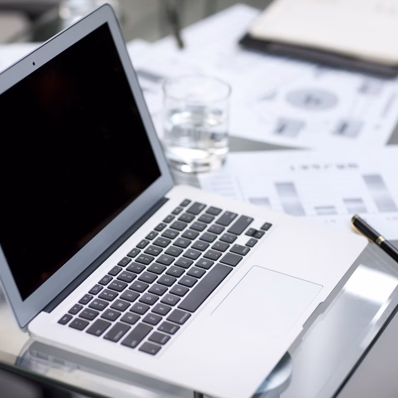 Laptop and business charts on desk