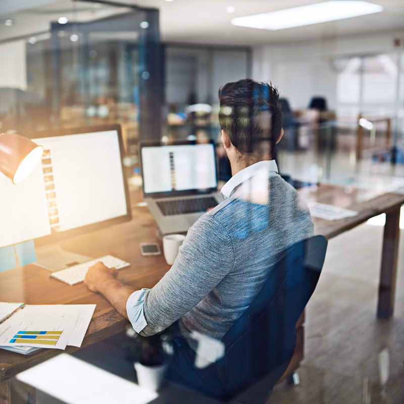 Businessman staying productive while working at his desk