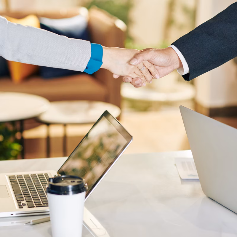 Business partners shaking hands after meeting