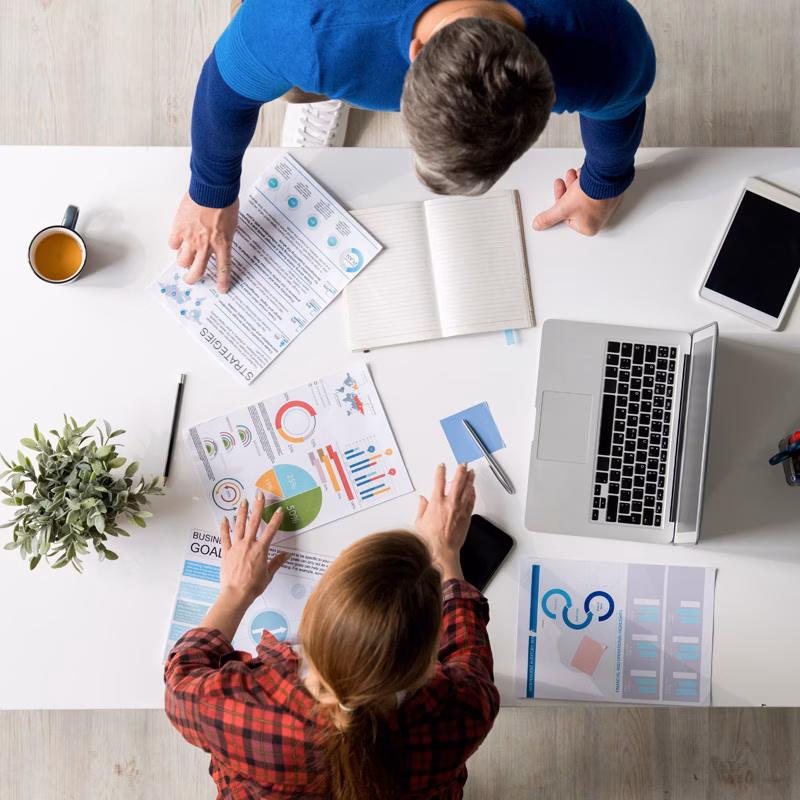 Marketing team reviewing charts and analytics from above