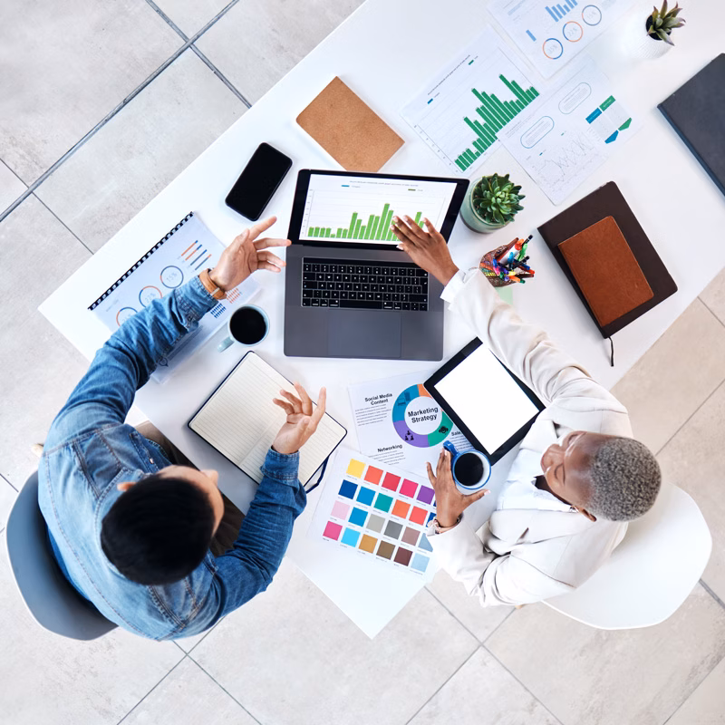 Overhead view of business people meeting with a laptop in an office